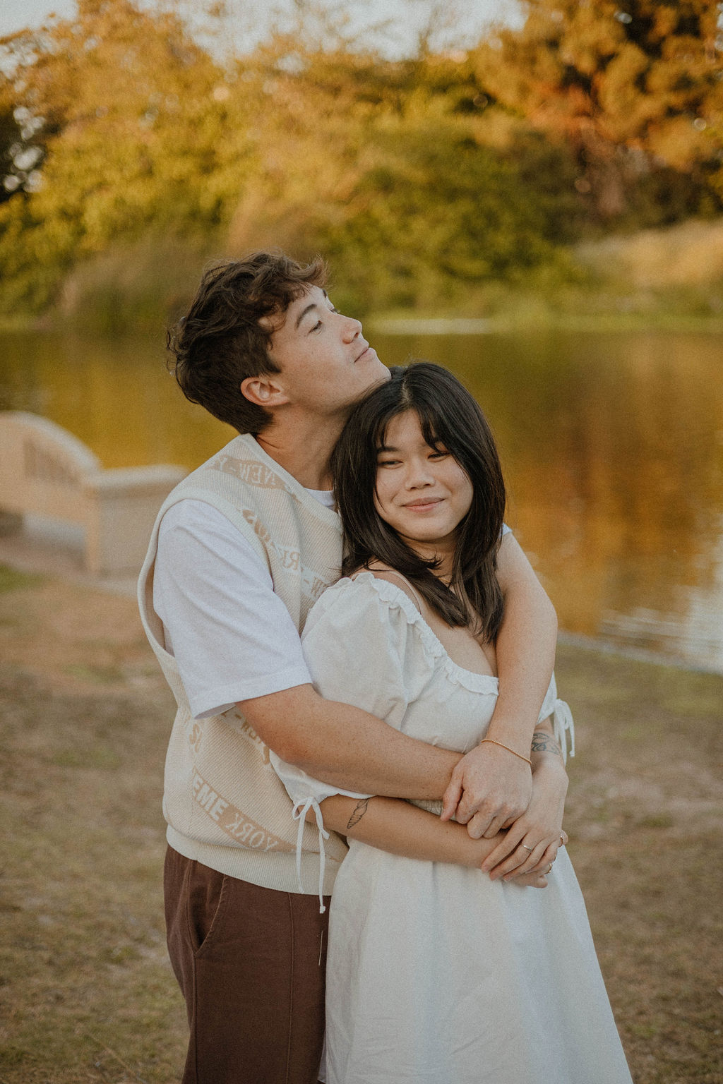 Boyfriend holding girlfriend alongside of the pond at Polliwog Park in California! 