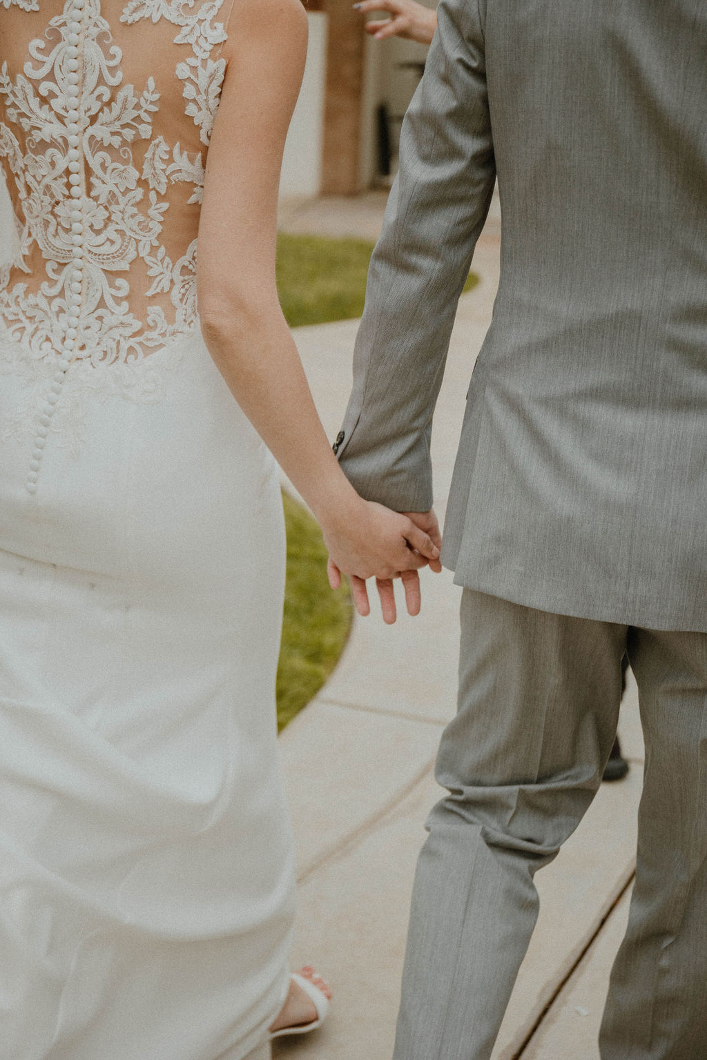 the couple holding hands as they walk at the California wedding venue