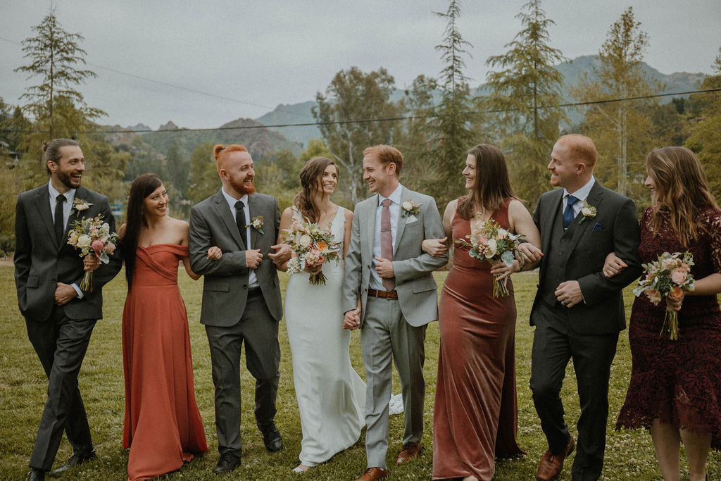 the bridal party laughing as the walk together at the California wedding venue