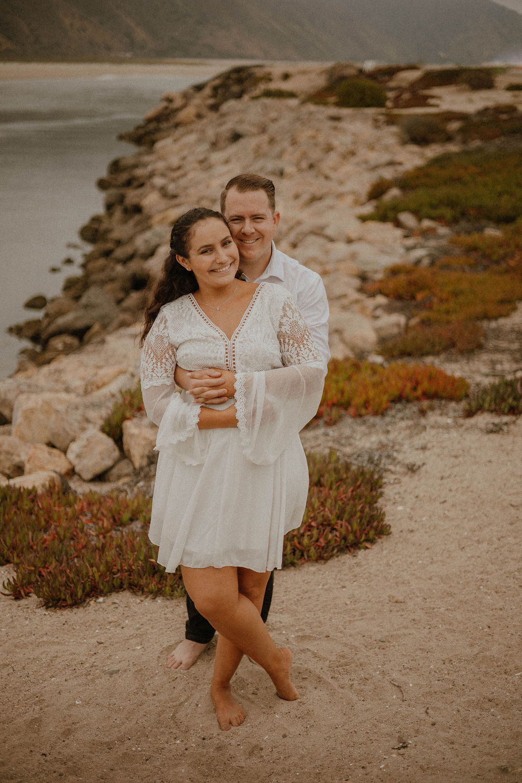 fiance wraps his arms around her for a cute photoshot