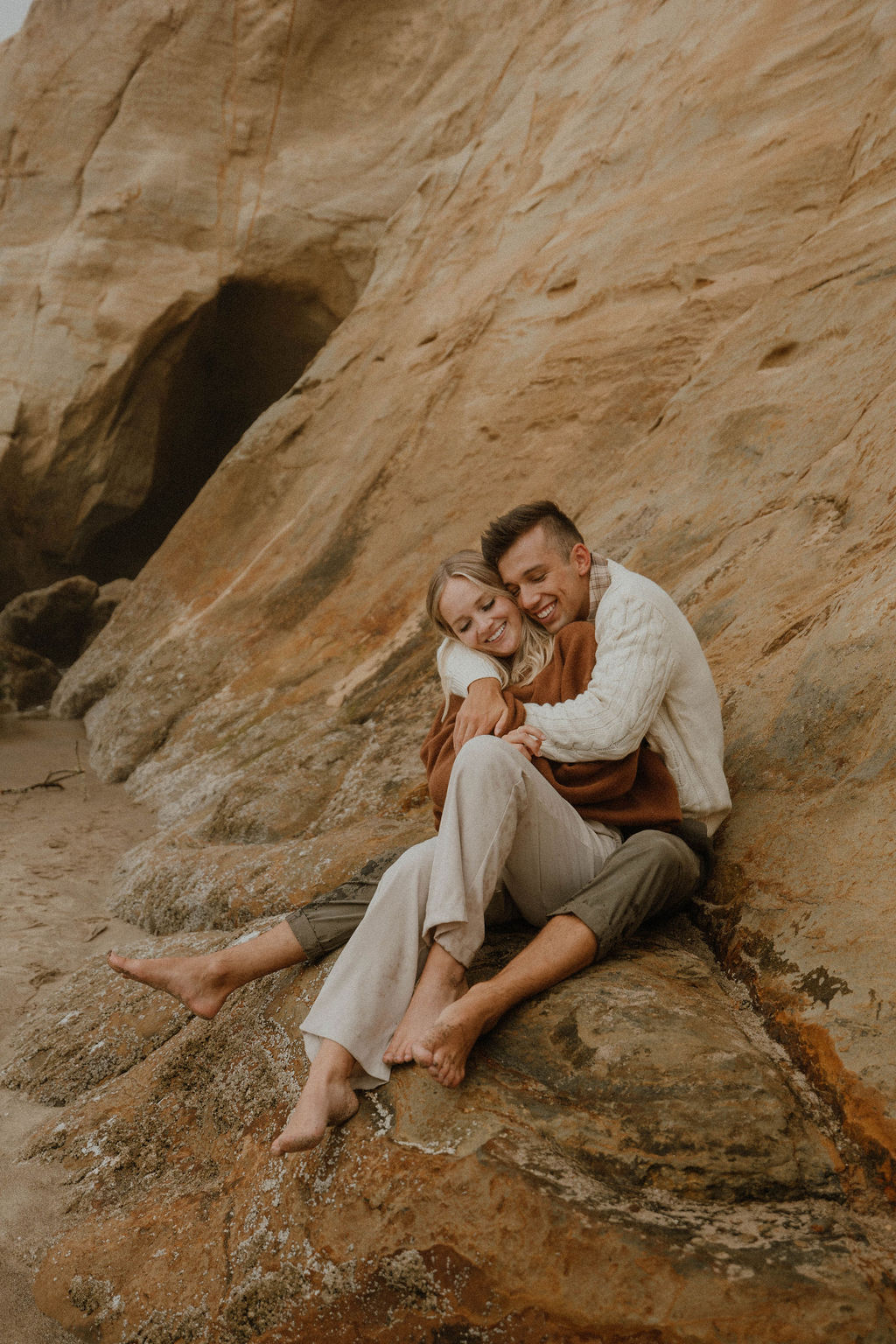 couple snuggling in close at their Oregon Beach photoshoot