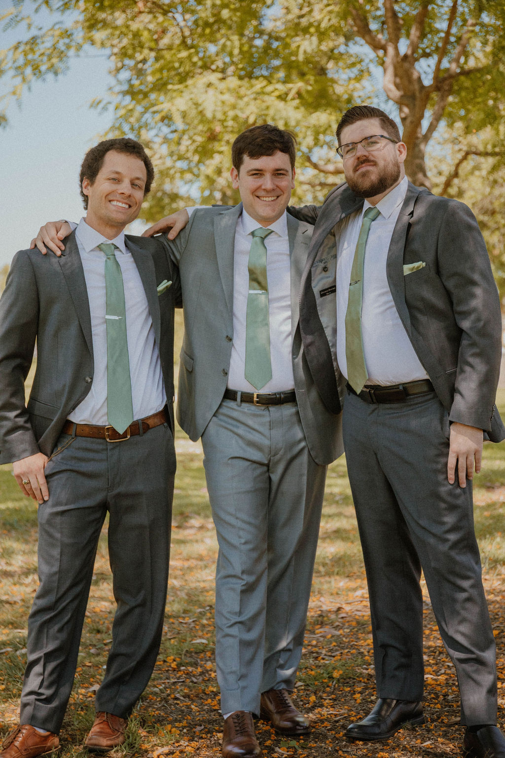 the groomsmen smiling at the wedding photographer