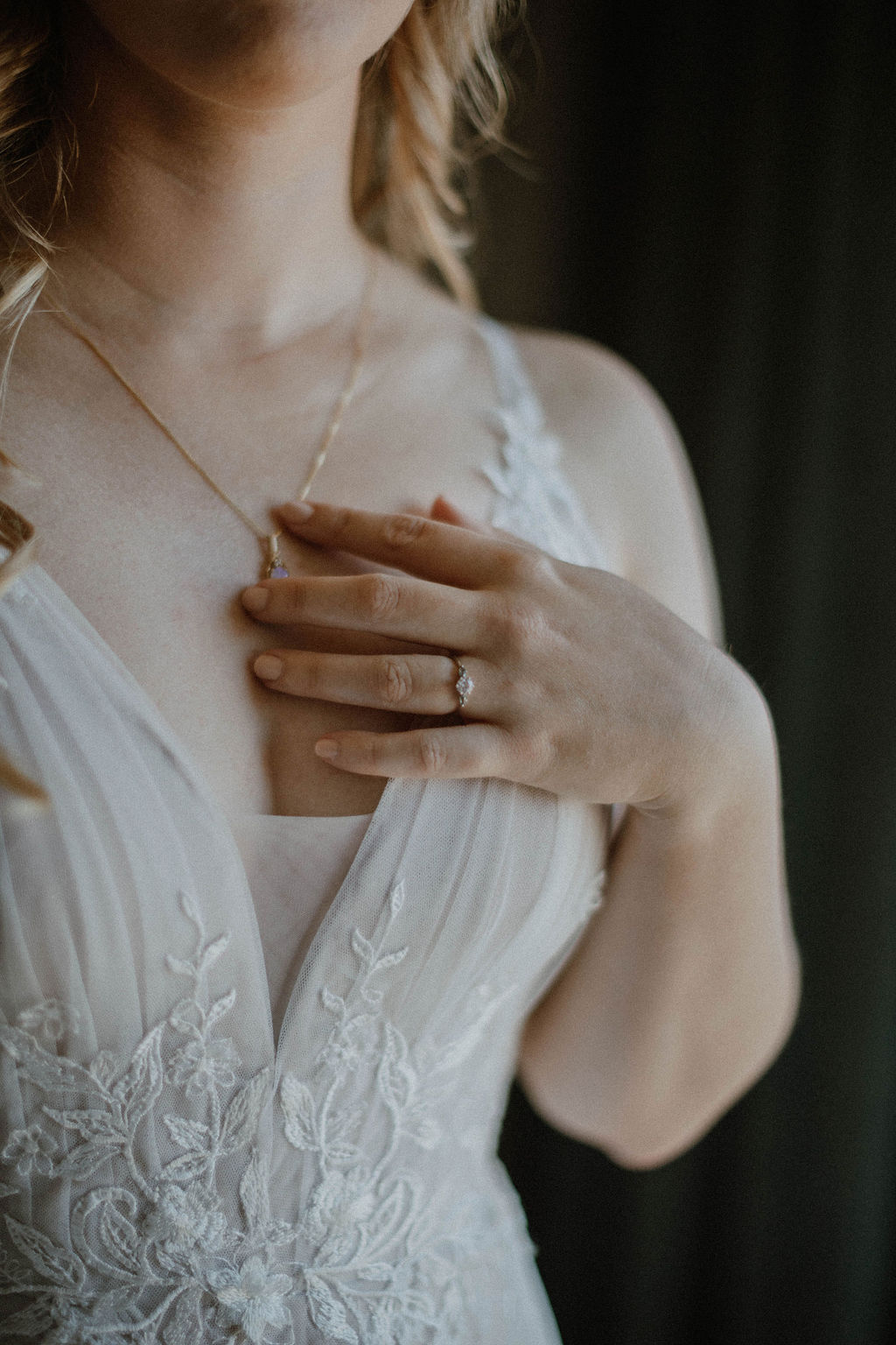 the bride touching her necklace