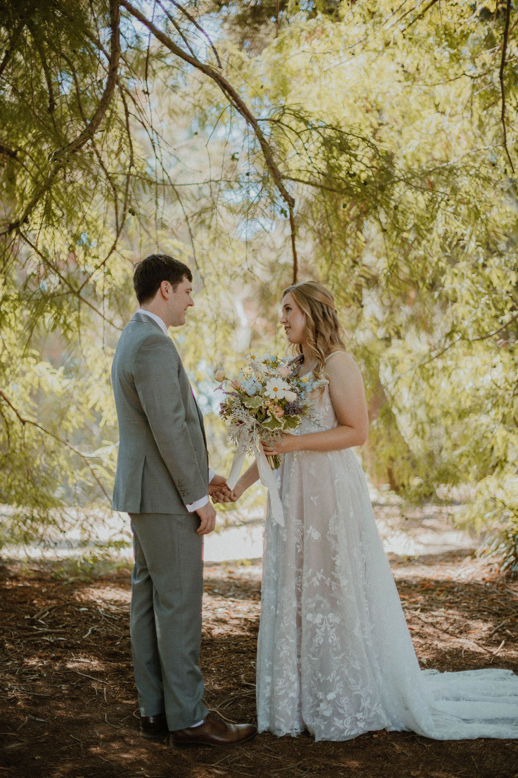 the couple holding hands after the first look at their Fullerton Arboretum Wedding