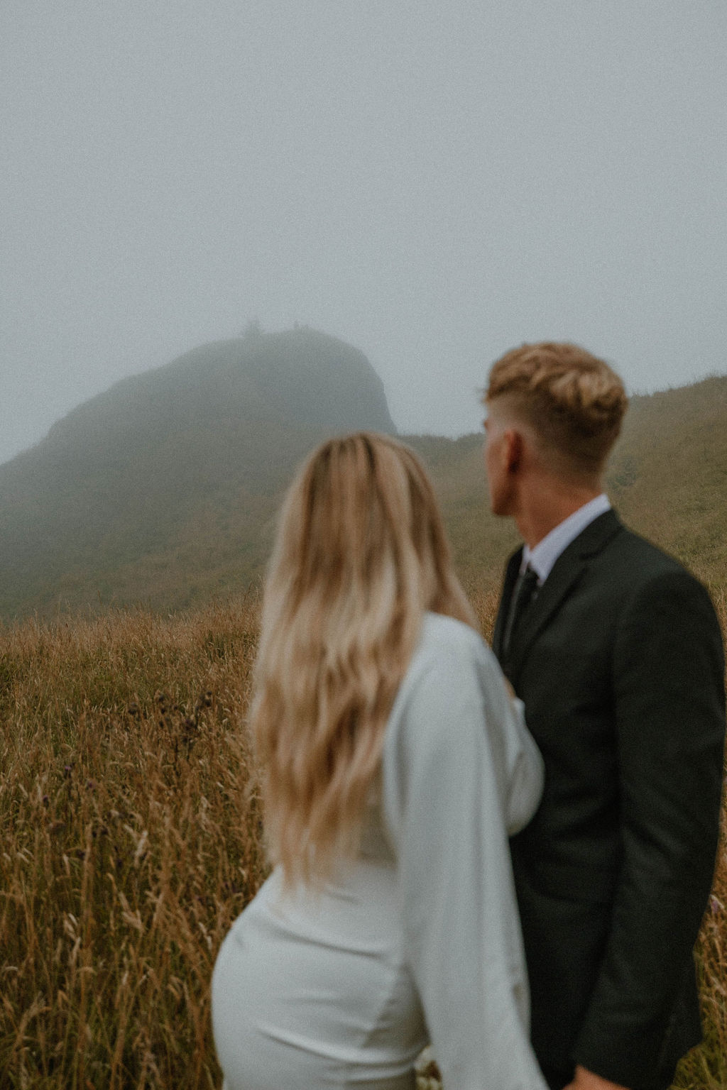the bride and groom standing in the Oregon fog