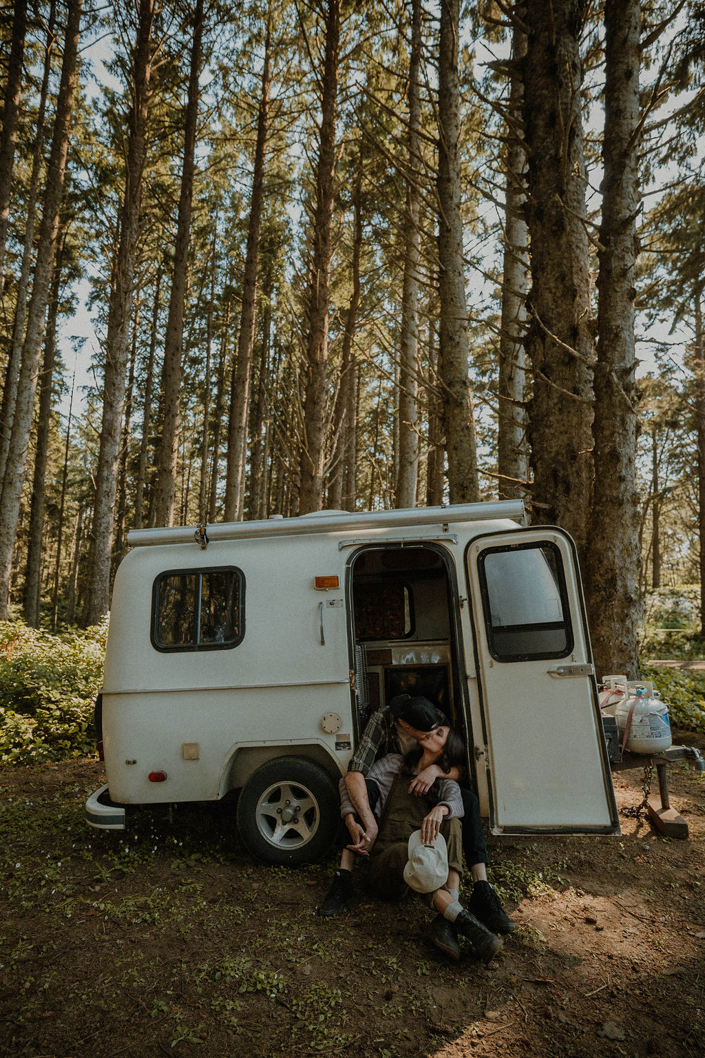 the couple standing sitting together in their camper