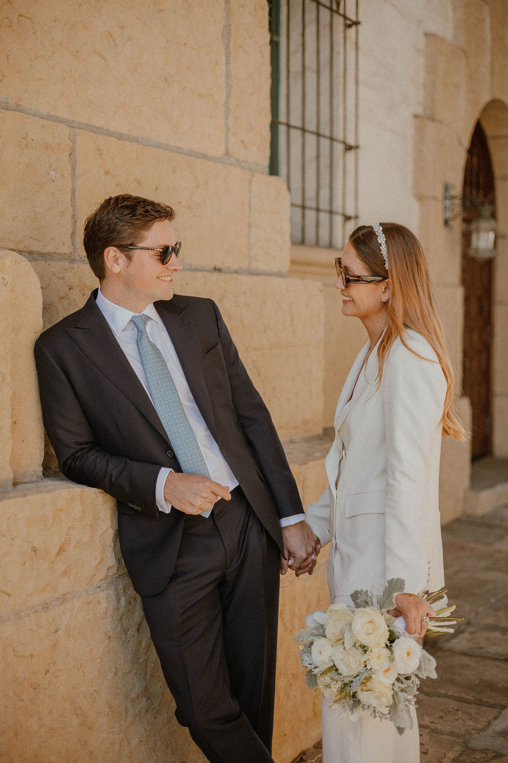 the couple looking at each other with their sunglasses on