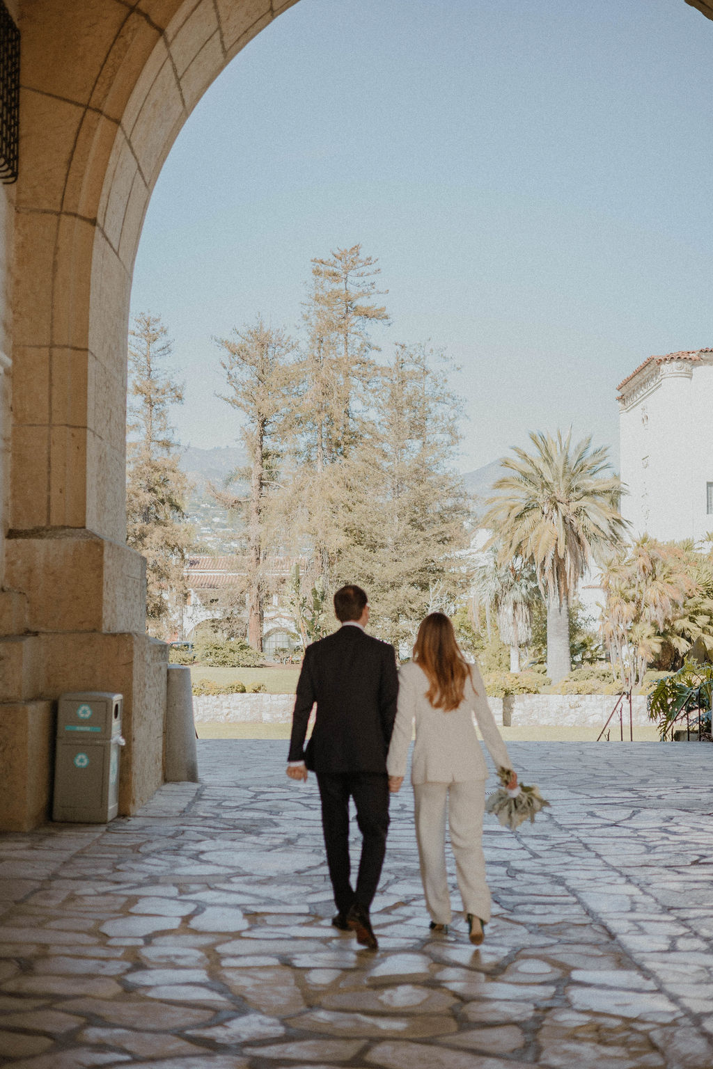 the couple walking away from their Santa Barbara Courthouse Wedding