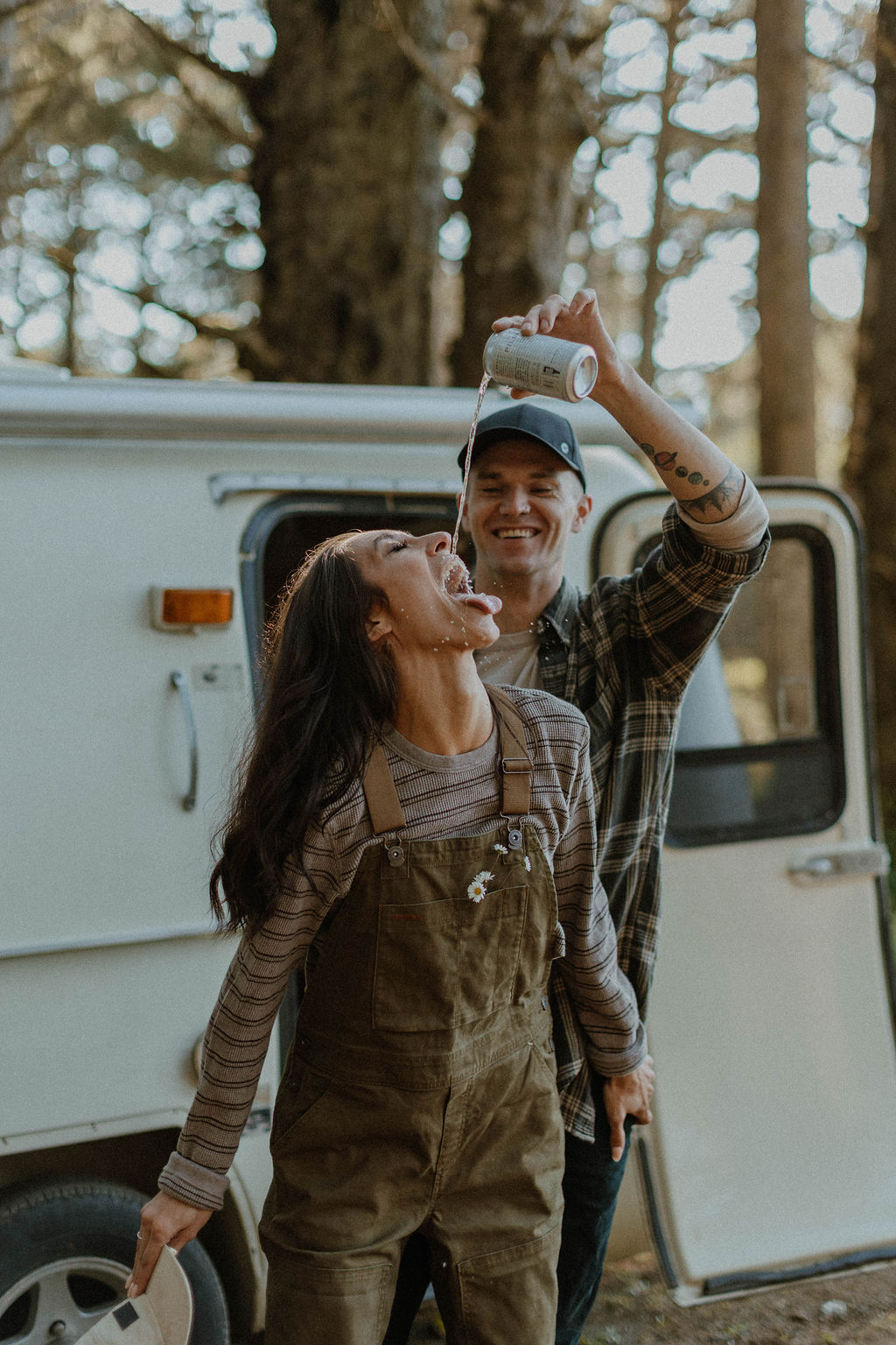 the couple having fun and drinking at their camp photoshoot