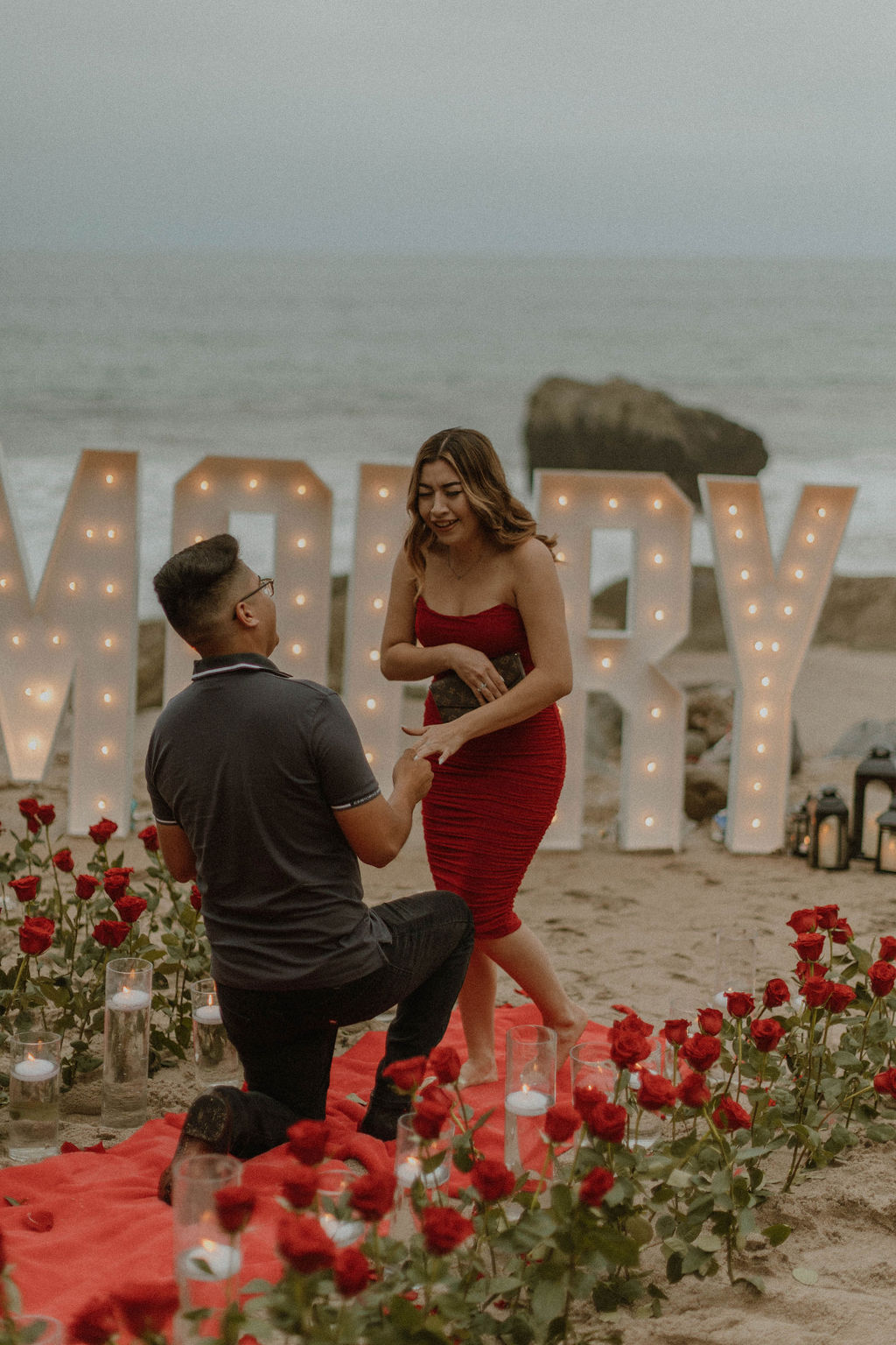 the couple on the beach during their proposal